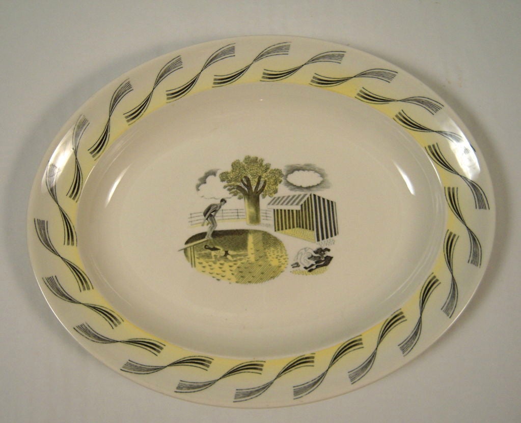 A rare Eric Ravilious  designed oval platter for Wedgwood  from the Garden Series, depicting a diver and a swimmer in a pool, next to a striped canvas cabana, in transfer printed black with yellow highlights.  Signed.<br />
Ravilious studied at