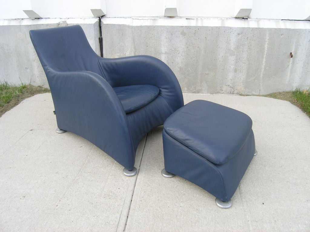This wonderful, whimsical armchair is just right for lounging. The low, angled seat and reclined back allow the user to relax comfortably. The curvy, streamlined shape makes this piece a focal point in any living space. The metal disk feet are