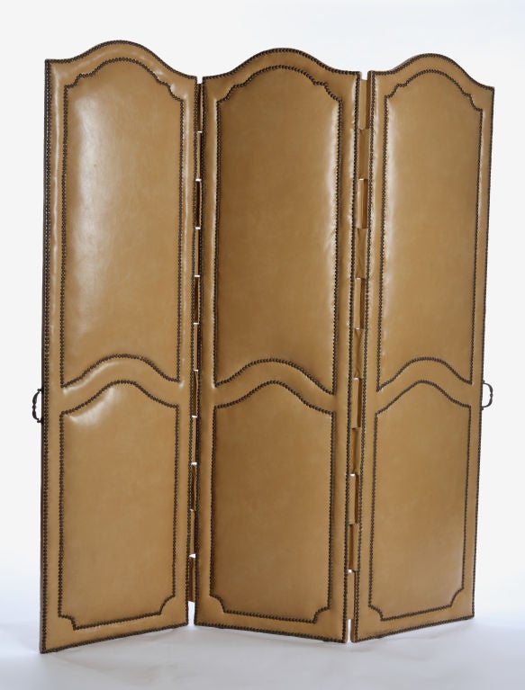 SALE / $1,120 / ORIGINAL PRICE $2,800<br />
+ A timeless three panel leather folding screen<br />
+ Original leather in fabulous condition (newly cleaned)<br />
+ Nailhead detail throughout<br />
+ Oxidized brass handle on side of two outer