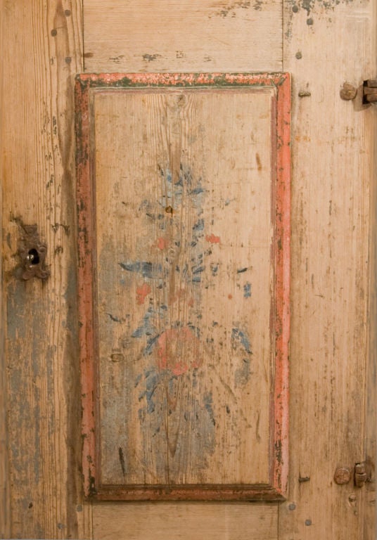 Primitive 18th century Swedish one door cabinet with trace remains of the original paint; heroic proportions.  From the Allmoge region.