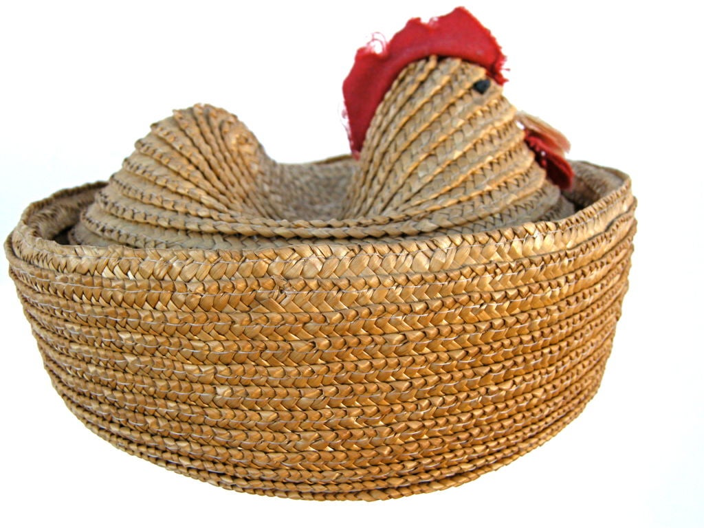 A folky small scale, woven straw basket designed to replicate a nesting chicken. Of southern Georgia origins. It's simple handmade composition adds to it's style and whimsy