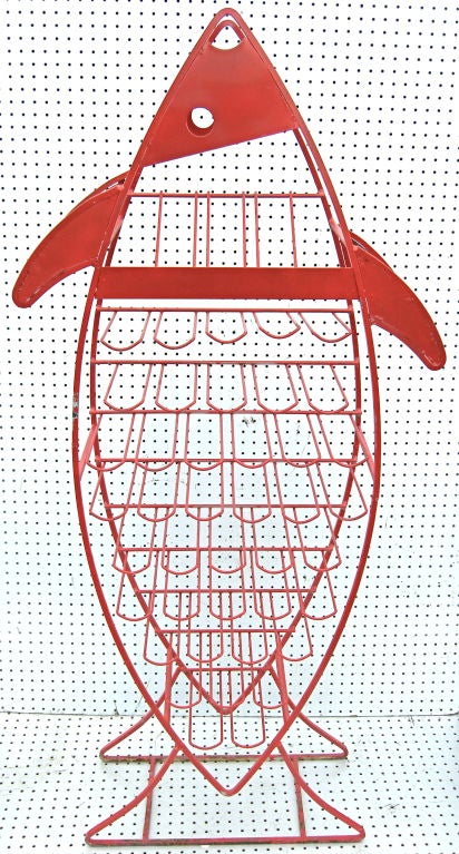 A highly amusing and graphic wine rack in an extra large fish motif. Casting a colorful and whimsically sculptural presence, it is sure to command the attention of all wine aficionados. Perfect for the aquatic inclined.