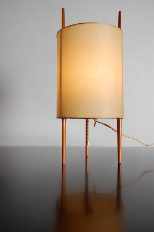 Isamu Noguchi for Knoll triped desk lamp with cherrywood legs and a polyvinyl shade .