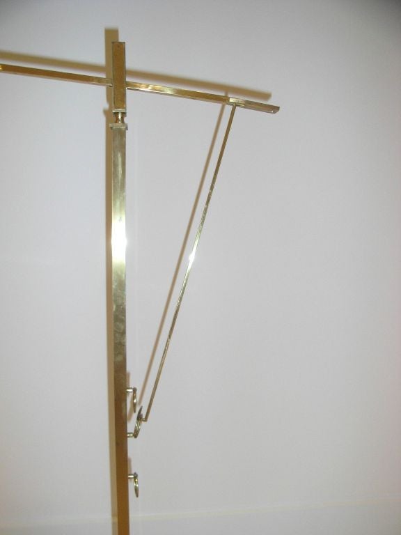 Elegant articulated Standard lamp in the manner of  Jacques Quinet. The arm can be moved into three positions and is held in place by brass rings. The shade is original.