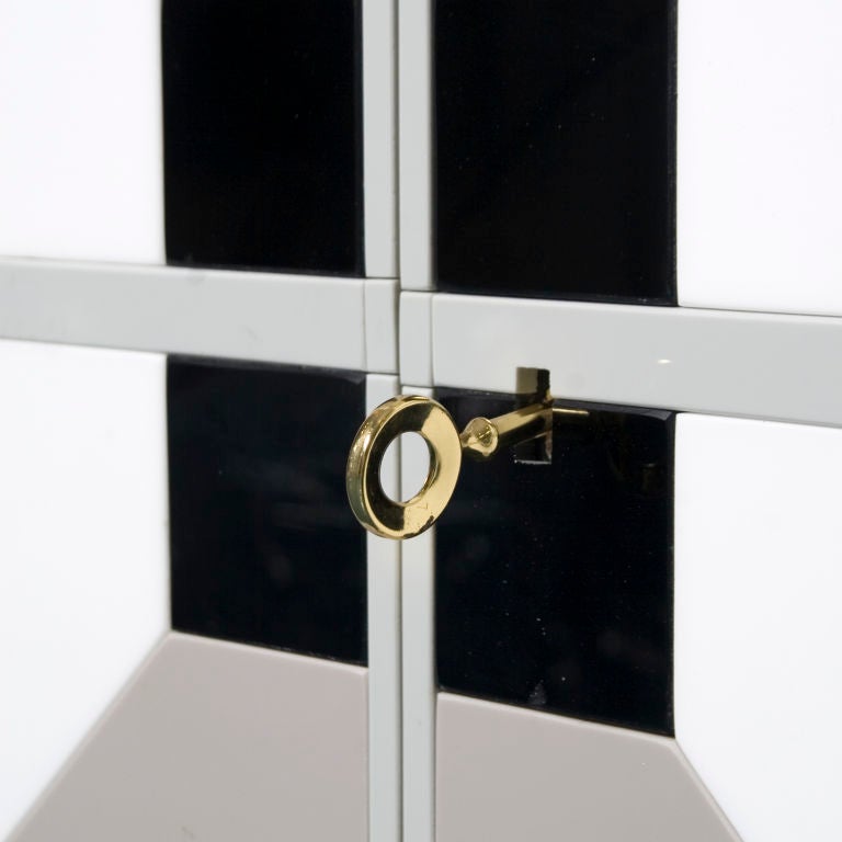 Two door glass cabinet, 'Prospettive', designed by Roberto Guilio Rida. The cabinet has brass legs and a maple interior.It is formed from hand cut coloured glass pieces.<br />
This unique piece is sold with a Certificate of Authenticity from the