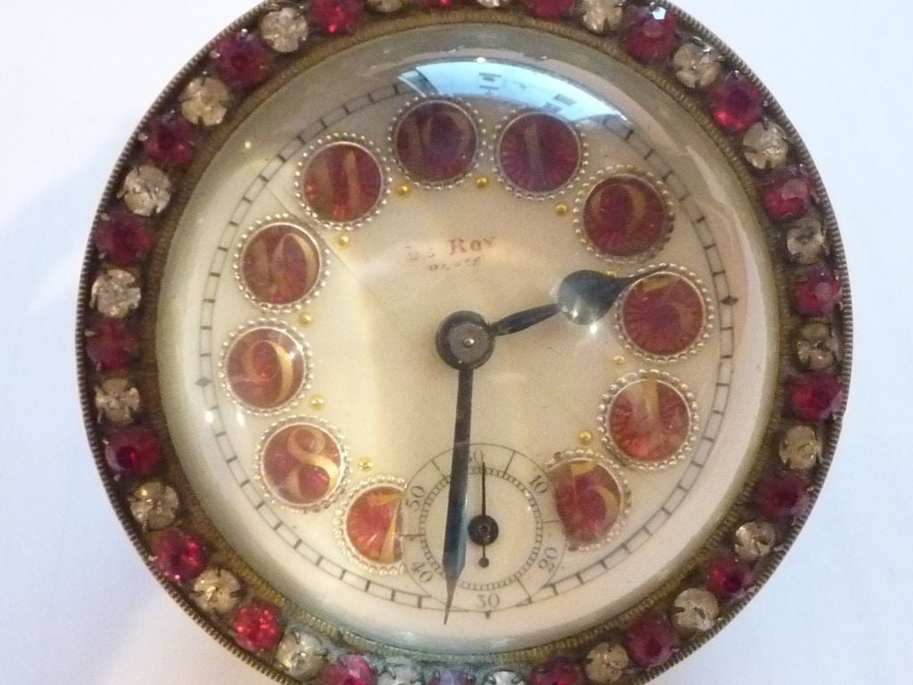 Ball clock with red and clear paste surround and coloured numerals, by Le Roy of Paris, c1920 
Provenance- Julien LeRoy(1686-1759) of Paris is credited with introducing circular wire gongs in place of bells into the strike train of clocks.  He