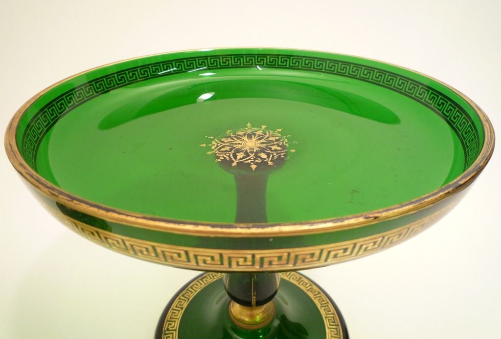 Garniture of five gilt and green glass tazzas, c.1890<br />
The set being made up of two large, two medium and one small; all with gilt Greek Key design on base and dish.<br />
<br />
<br />
From 15cm to 20cm high (6 inches to 7.8 inches high)