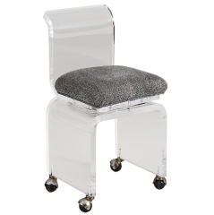 A Small Lucite Swivel Vanity Chair on Castors