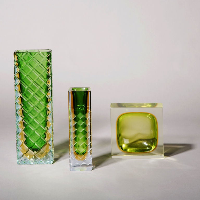 A Collection of Murano Sommerso Glass Vases and Ashtrays in varying Shapes and Sizes in Emereld Green and Gold Centres Cased in Clear Glass Italy 1960/70s<br />
 <br />
From Left to right:<br />
SN: L5981<br />
A Large Square Murano Sommerso
