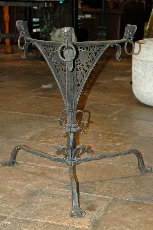 Unique hand forged iron table base. Incredible detailed & hand pierced construction, with ornamental details complete with mythological dragon heads and animal feet. Northern European, possibly 15-16th century, or earlier. 

The table base