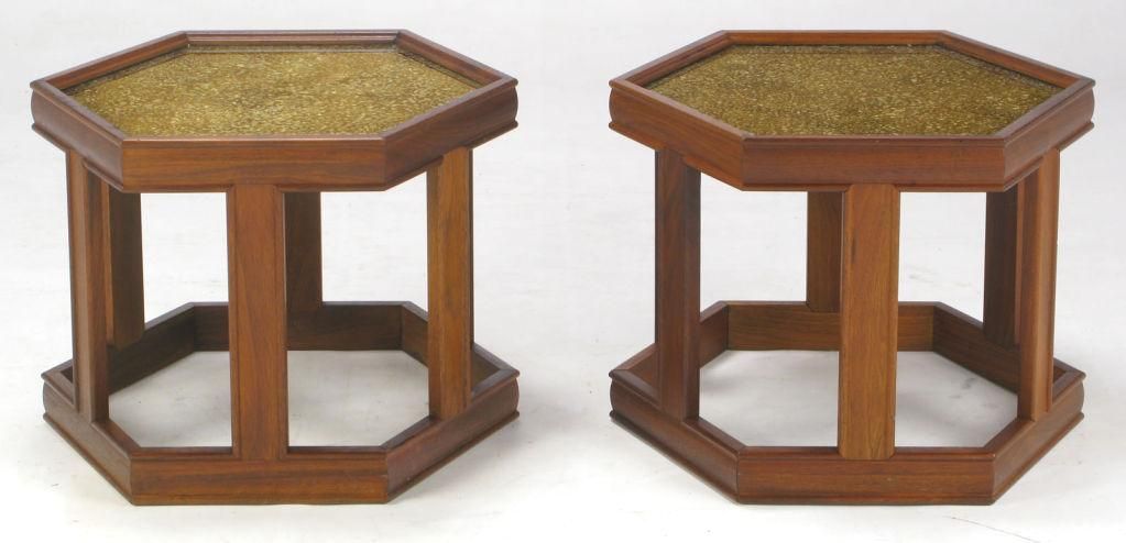 Pair of hexagonal side tables by John Keal for Brown Saltman. Finished in a medium walnut, with a brilliant reverse-painted and textured glass top in gold and taupe tones.  Grouped as a pair, they would function well as a coffee table.