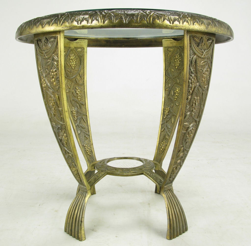 A petite cast iron art deco  side table created by Seville Studios.  Seville Art Metal Studios operated in Cleveland, Ohio for a short time from  the 1920s-30s. Original bronze finish, over cast iron, is adorned with grape vines and art nouveau swag