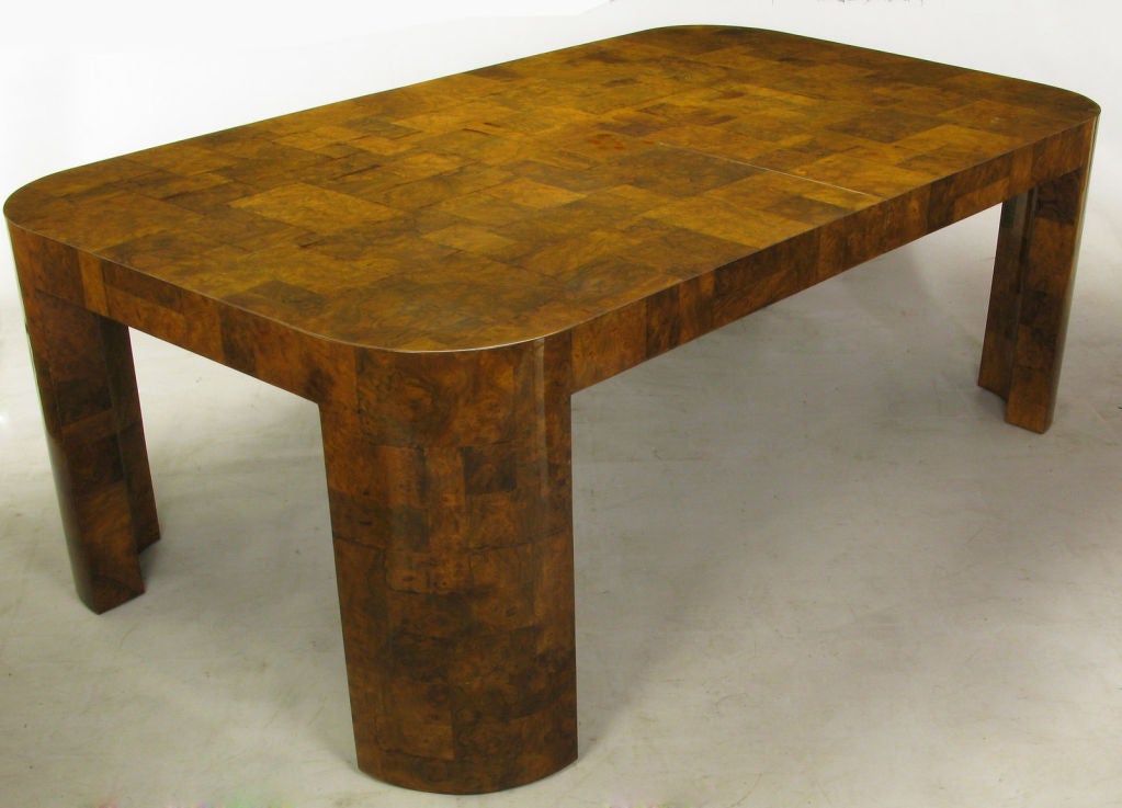 An excellent example of the modern elegance that was Paul Evans' work for Directional in the late 1960s through the middle 1970s. This patchwork dining table in burled walnut has radius corners and legs. The fine burled walnut veneer of various