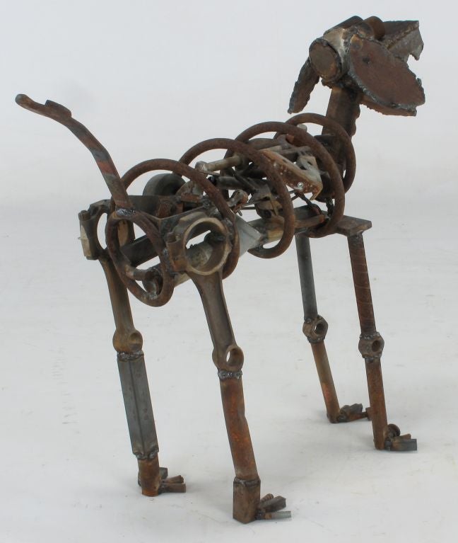 Awesome welded iron dog sculpture composed of antique iron tools, springs, bolts, nuts and torch cut sheet metal and reinforcing bar pieces. Signed K.P.