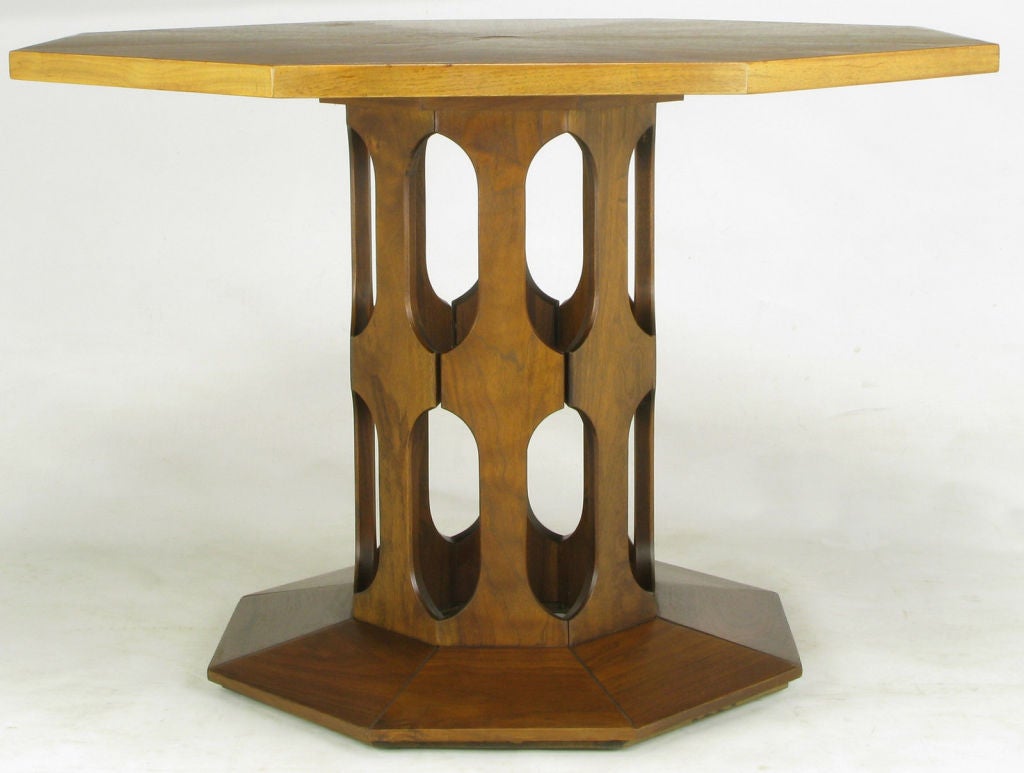 This center/game table features an open geometric shaped figural walnut pedestal base and radial bleached mahogany top.  Attributed to Harvey Probber.