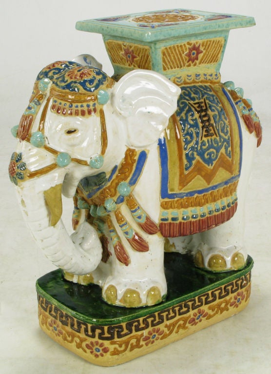 Colorfully hand painted and glazed ceramic elephant garden seat, or table, on plinth base.