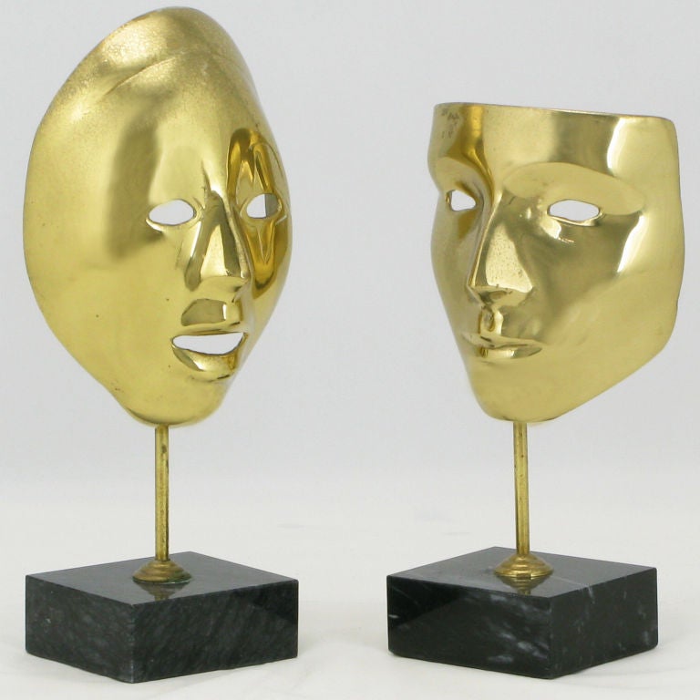 Equisite pair of cast brass Carnivale masks mounted on black marble plinth bases. Very nicely patinated.