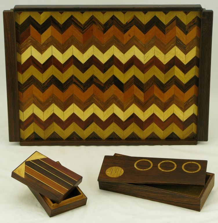 Handled tray with herringbone, or chevron, parquetry wood inlay consisting of rosewood, walnut and teak wood. Two complementary boxes, not Shoemaker designs, are rosewood with inlaid tops. The longer box, made in Italy, has cork lining and lighter