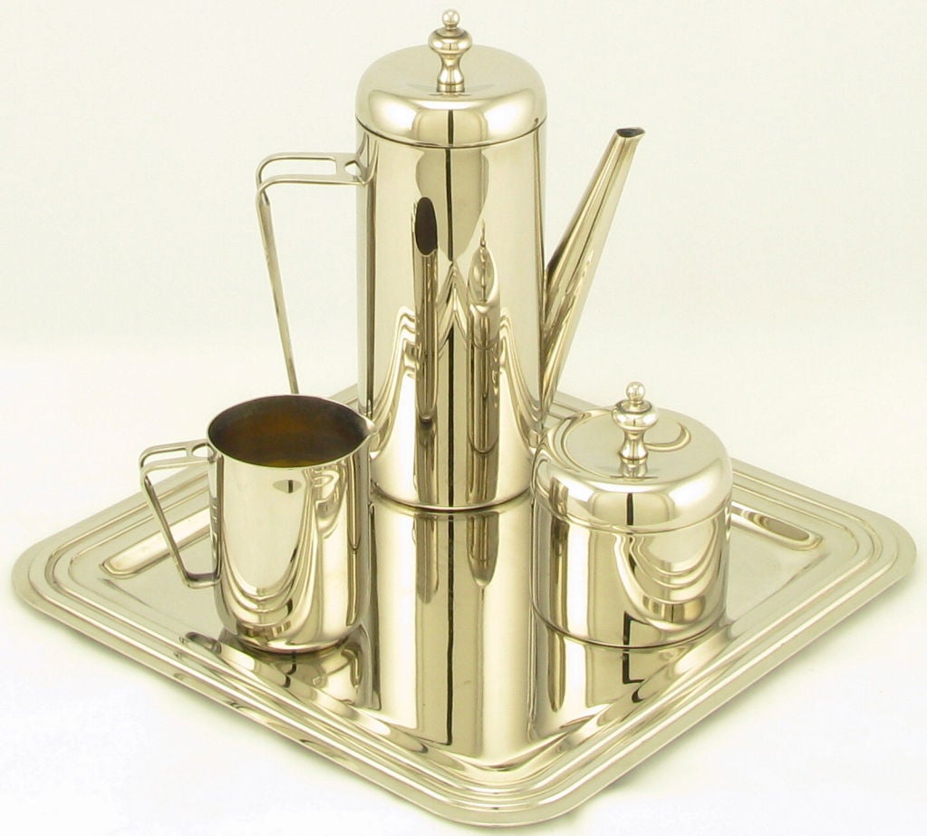 Elegant silver plated coffee service with coffee decanter, creamer and covered sugar bowl with recessed tray by Regal Silver.