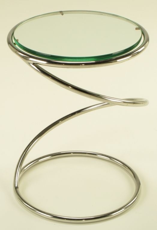 Coiled spring occasional table of chromed steel with a one-half inch thick glass top by Pace Collection.