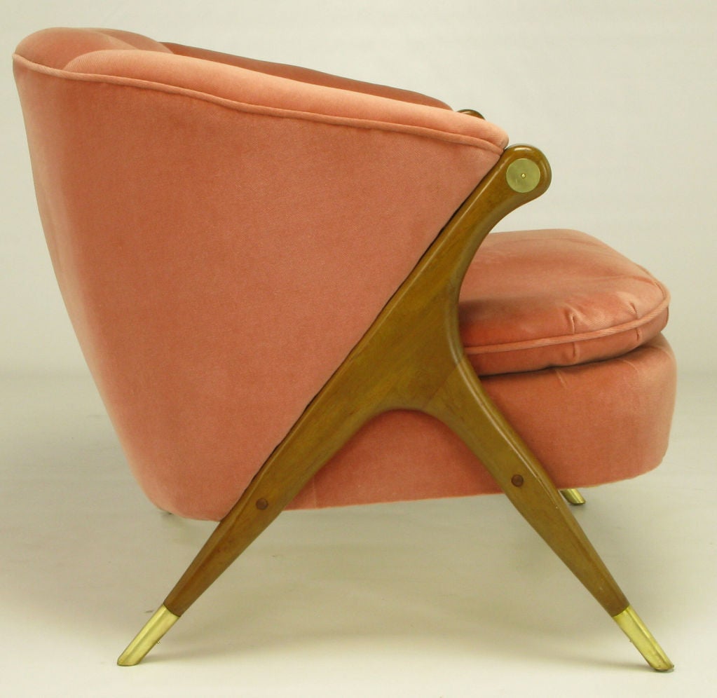 Elegant and unusual, this single channel back lounge chair by Karpen is clad in rose pink mohair. Legs are quite sculptural with carved walnut three point design. Brass sabots and medallions.