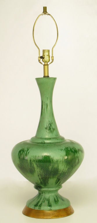 Elegant ceramic urn-form table lamp with a dual-tone and aged glaze. Gilt brass base and custom shade.
