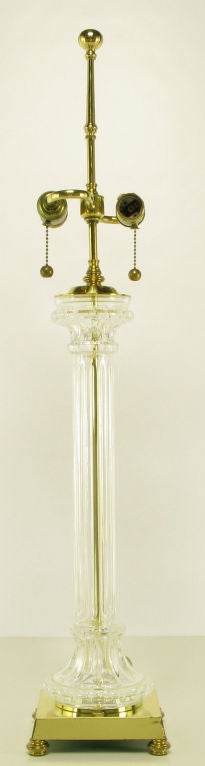 Heavy brass based crystal column table lamp with double socket illumination and brass ball and chain pulls. Tall brass riser and brass ball finial finish. By Speer.  Sold sans shade.