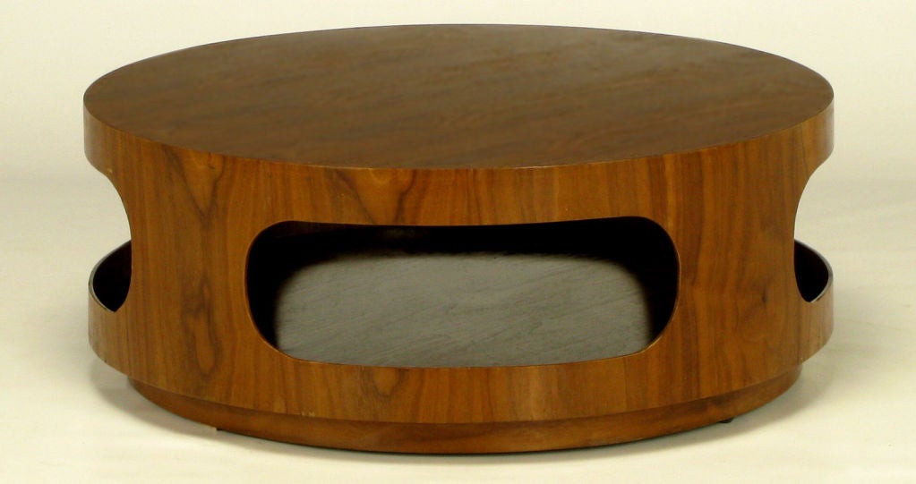 Modernist bent wood, walnut veneered coffee table with an open design. Four race track oval openings allow for access to the center. Recessed plinth base adds to the clean modern appeal.  In the style of Joe Colombo, and believed to be of Italian