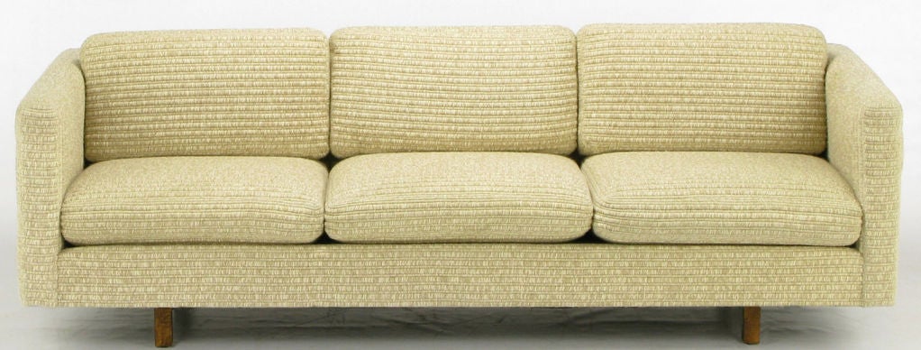 Even arm tuxedo sofa with loose seat and back cushions in a thick ribbed Haitian cotton upholstery and recessed square form wood legs. Evokes designs of Harvey Probber, and Charles Pfister for Knoll; very well made and heavy.