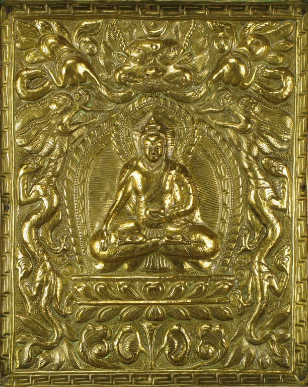 Well fabricated and jeweled relief of Buddha, in formed brass and copper over wood.
