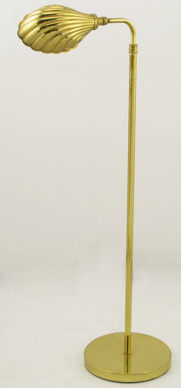 Brass floor/reading lamp with formed brass shell form shade. Incandescent lighting element, and 100 possible watts of illumination.