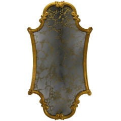 Miroir vénitien encadré en bois sculpté et doré