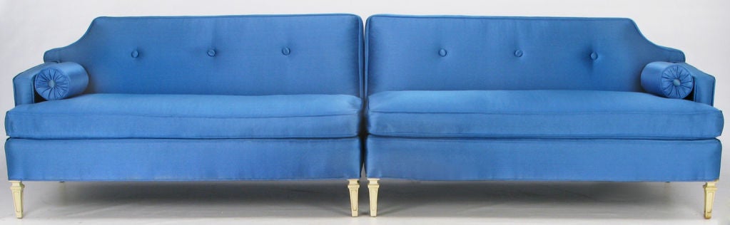 Royal blue silk upholstered two-piece sectional with aged white lacquer over carved wood regency style legs. As-new original button tuft silk upholstery lived its entire existence under plastic slipcovers.