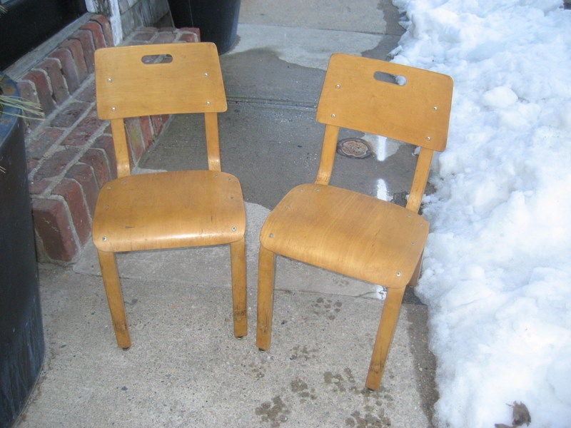 Rare set of 4 children's chairs with plywood seat and back in a honey finish with original labels from the store at 1 Park Avenue in New York....all stacking!