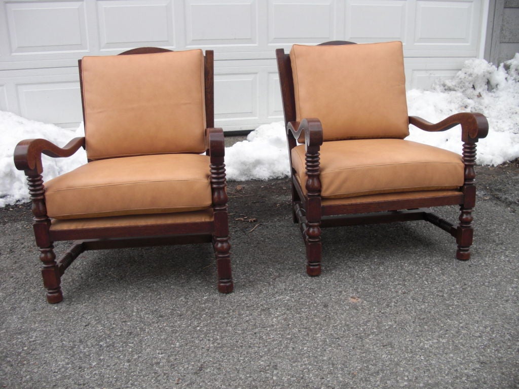 A pair of oak Arts and Crafts armchairs.