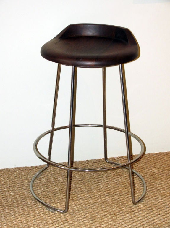 A set of three bar/counter stools by San Francisco-based<br />
McGuire furniture company. This streamlined Walnut Swivel Bar/Counter Stool has a solid satin finished walnut seat that cradles the body atop glossy steel tubing with a polished chrome