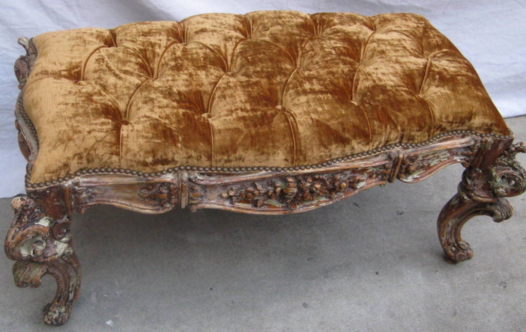 Carved rustic painted French bench with velvet upholstered top and nailhead trim deail around the perimeter of the top.