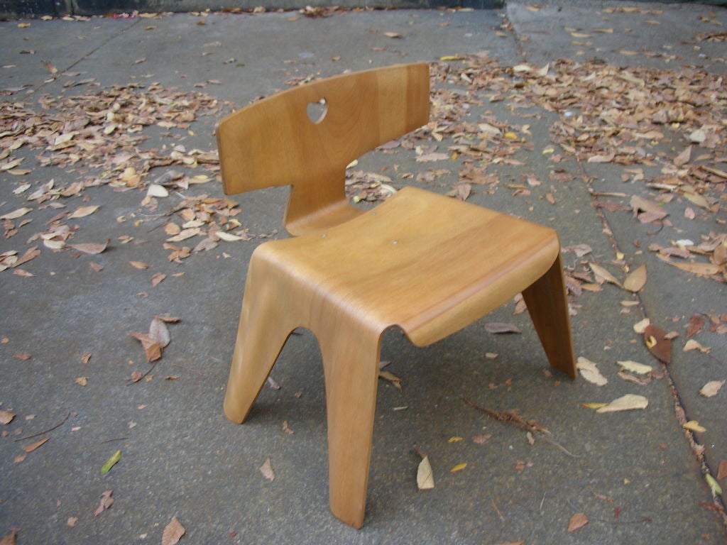 Very Rare and Hard to find Child's Chair with heart cut out designed by Charles and Ray Eames.  Designed in 1945 using wartime tooling.  The low chairs were made in two pieces: the back had an attached bracing unit, and the legs and the seat were