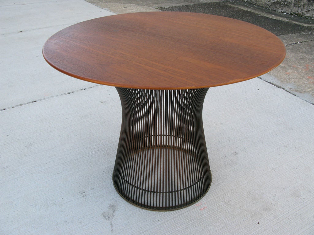 24 inch round walnut topped side table in very good original condition.No longer available bronze finished rods welded into an hourglass shape.