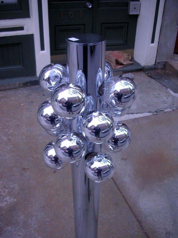 Floor lamp of chrome pillar with 16 mercury covered bulbs on a dimmer switch.