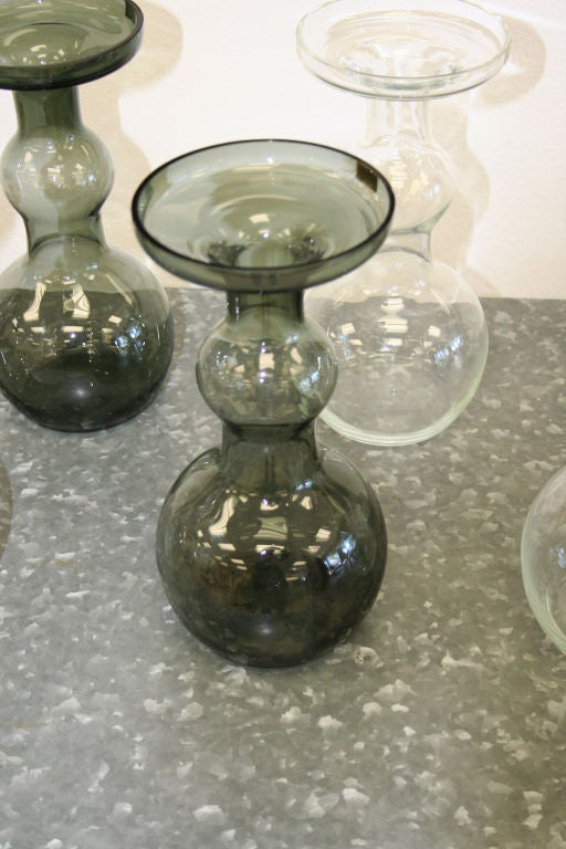 Collection of 8 Nuutajarvie Glass carafes,<br />
Made in Finland,each vase has a label<br />
priced as a set