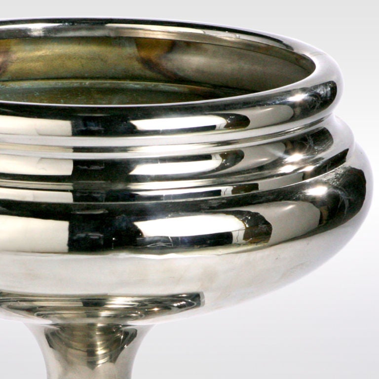 Dramatic oversized chrome centerpiece! This deco decorative bowl designed with concentric geometric circles is raised on hexagonal platform base.