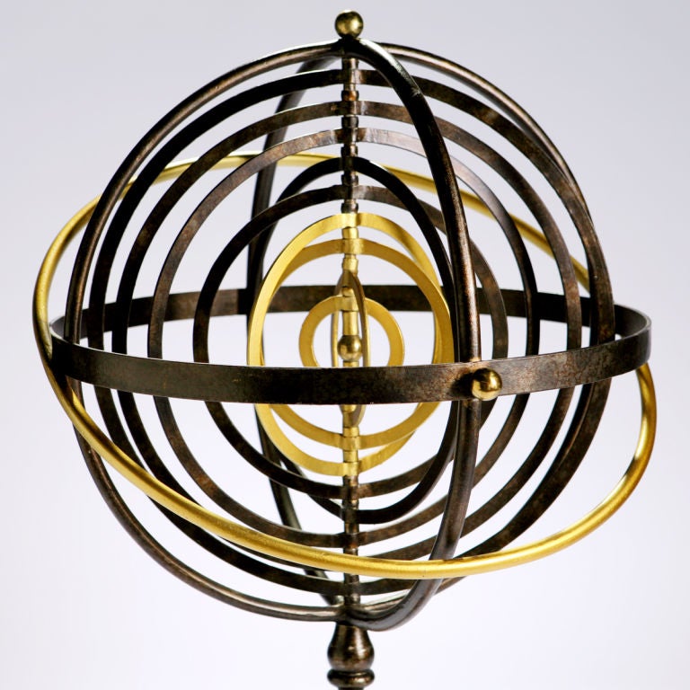 Large cast iron armillary:  old astronomical instrument, the rings of which illustrate the varying positions of celestial bodies.  Five black iron and four painted gold gilt concentric bands within a cast iron and gold circular support frame are