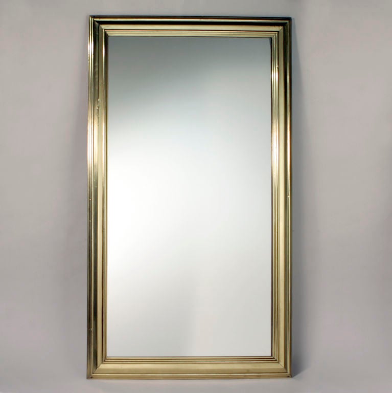 Oversized English pub mirror with wide brass frame.