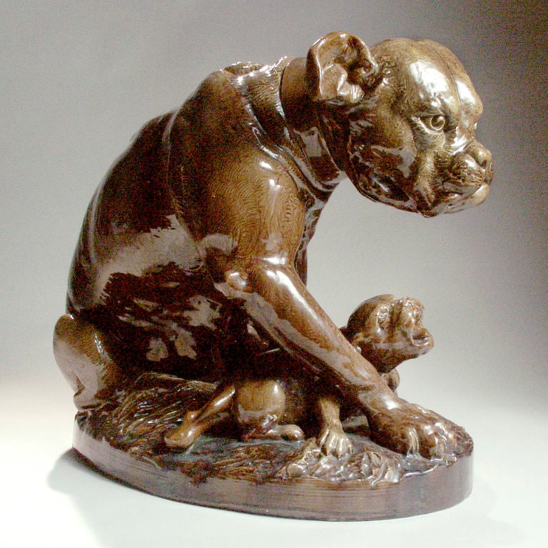 Realistic ceramic grouping of old fashioned type bulldogs showing the mother and two small pups in a life-like pose. Finished in a brown ceramic glaze.