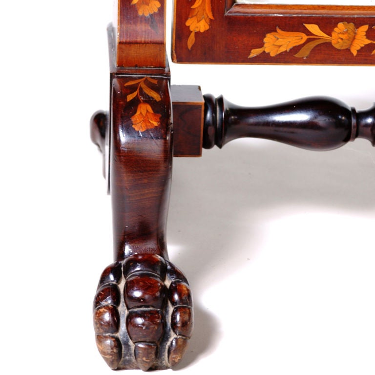 Tall 19th century Dutch marquetry cheval mirror with fine fruitwood inlay in a flower and leaf pattern.  Traditional hanging swivel mirror designed with sculpted crown top and beveled mirror on stretcher with carved paw feet.