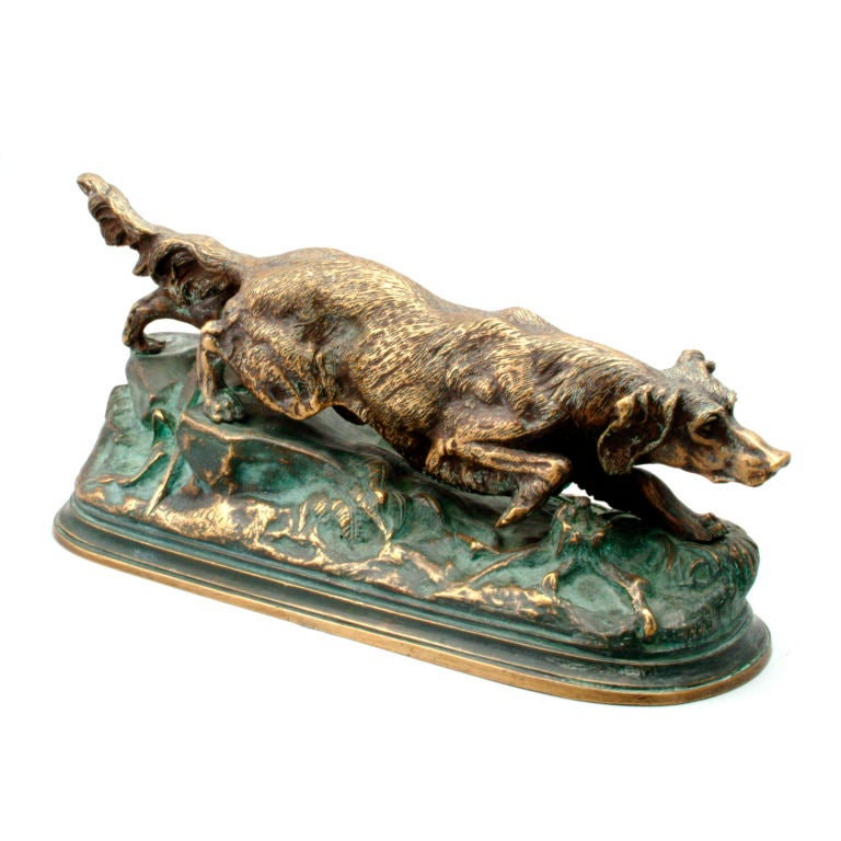 French bronze sculpture of Irish setter crouched in traditional hunting position. Mounted on raised bronze oval base. Signed: J. Moigniez.