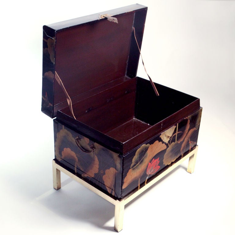 Black lacquer Chinese tea chest with red and gold lotus flowers detailed with birds. Brass handles, escutcheon and separate brass stand.