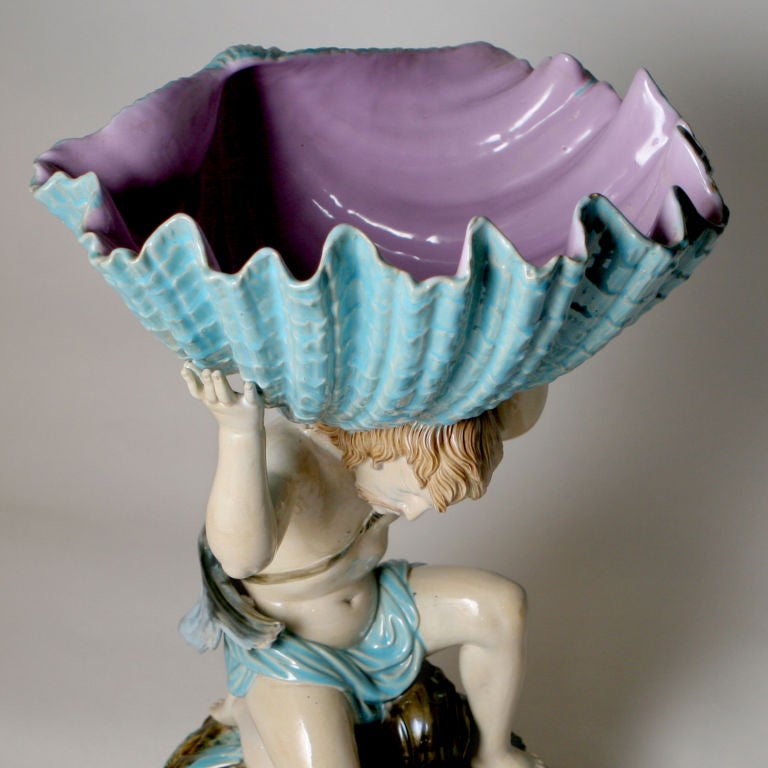 Large George Jones Majolica centrepiece with a kneeling Neptune figure over a dolphin while supporting a large turquoise shell over his head. Pattern #3320.