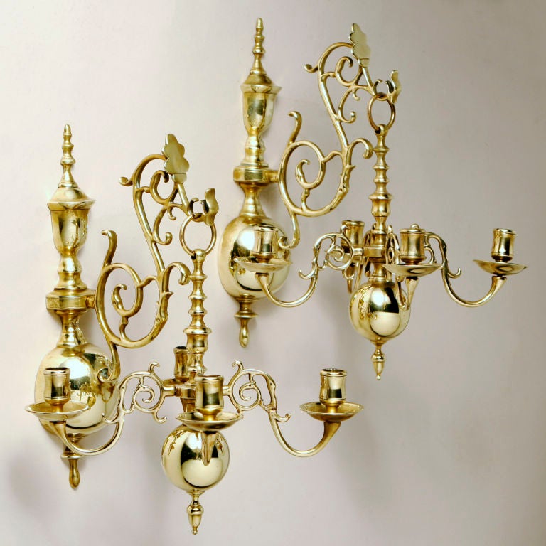 Hard-to-find pair of antique English brass wall sconces in Classic large ball design. Beautiful arched scrolled arm piece extends to support hanging candelabra. Four candleholders on each sconce. Not electrified. See our companion chandelier.